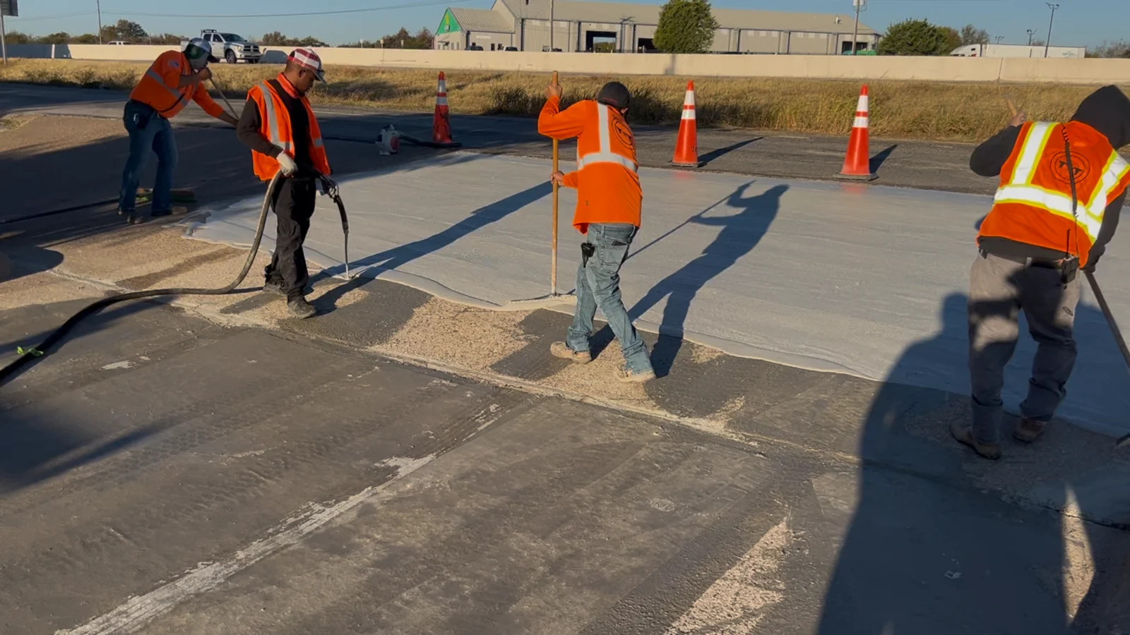 Crew placing and finishing PetraTec HP on a transportation concrete repair area