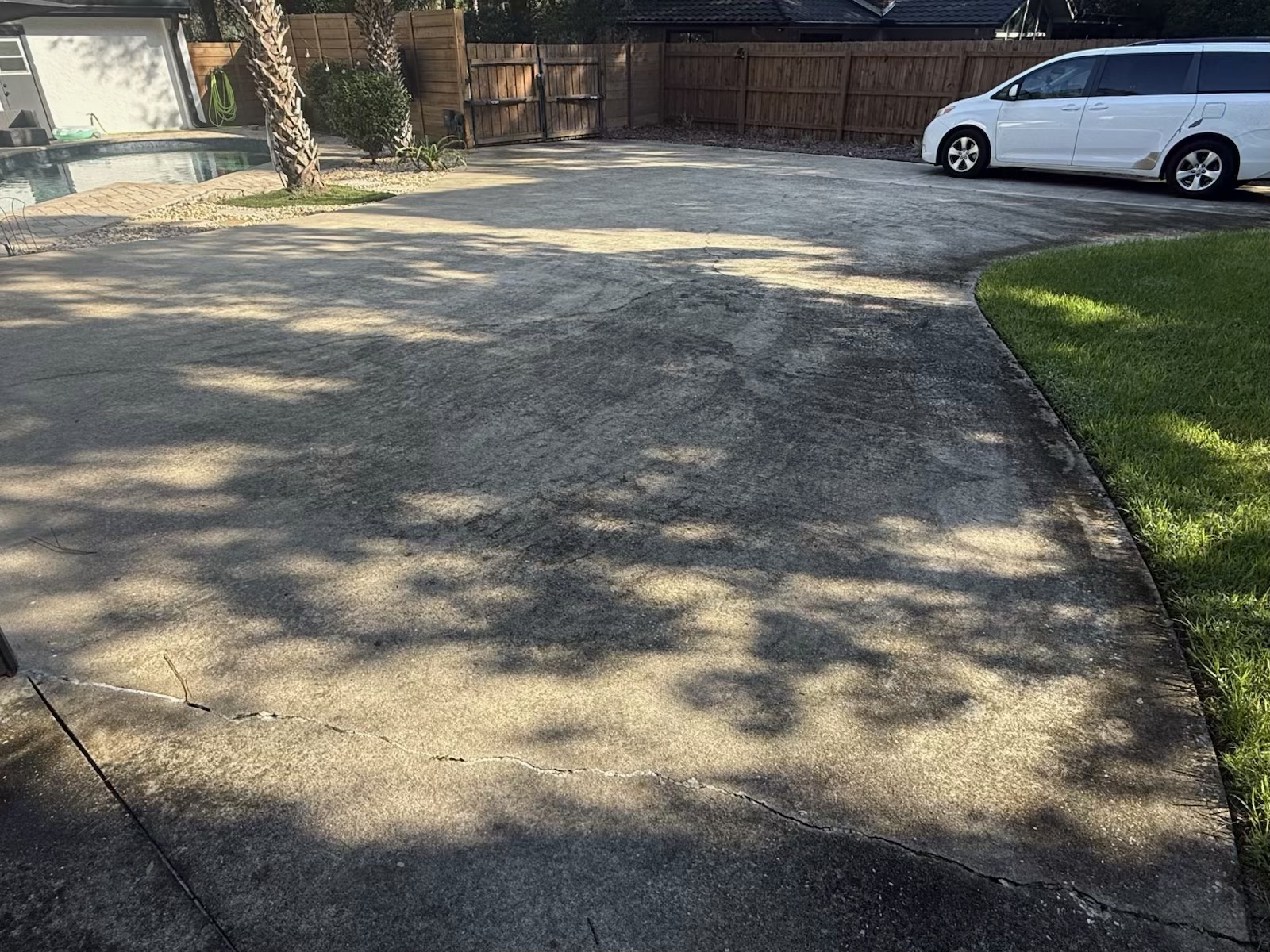 Worn and cracked concrete driveway before PetraReGen resurfacing
